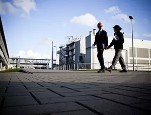 Man walking behind a building